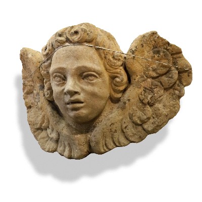 Antica testa di putto alato. Epoca 1400. 